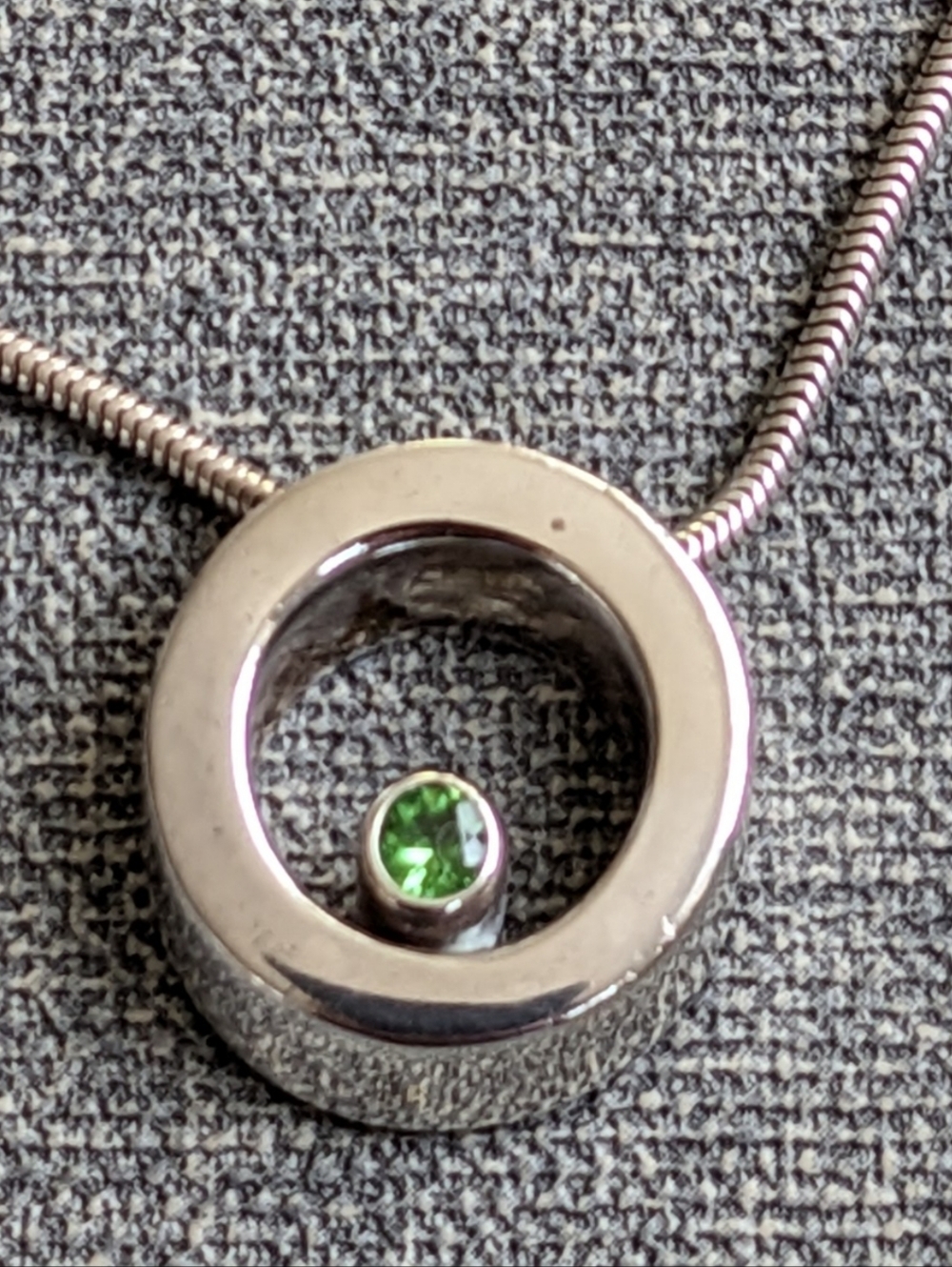 Movado 3D circle necklace with genuine peridot stone Vintage